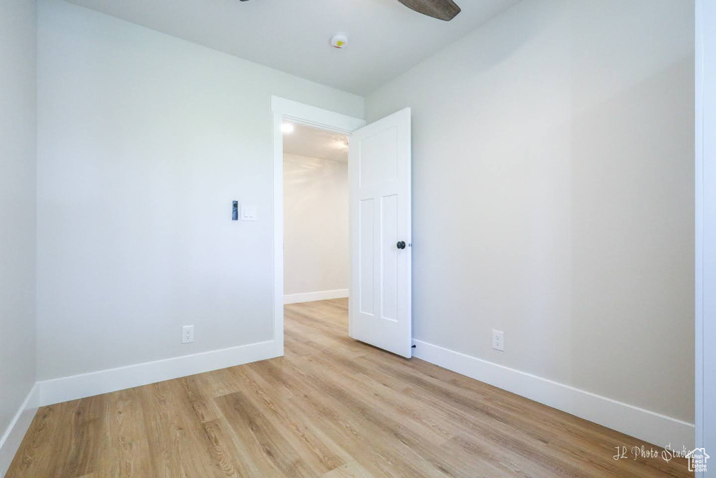 Empty room featuring light hardwood / wood-style floors and ceiling fan