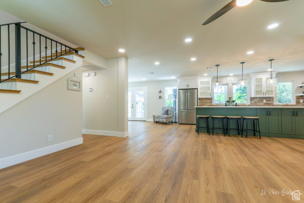 Living room featuring ceiling fan, light hardwood / wood-style floors, and french doors