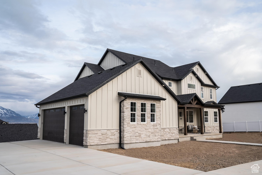 View of front of home featuring a garage and a mountain view