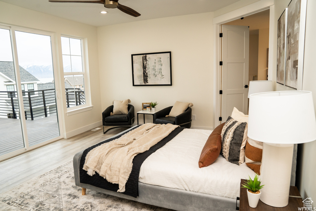 Bedroom featuring hardwood / wood-style flooring, ceiling fan, and access to exterior