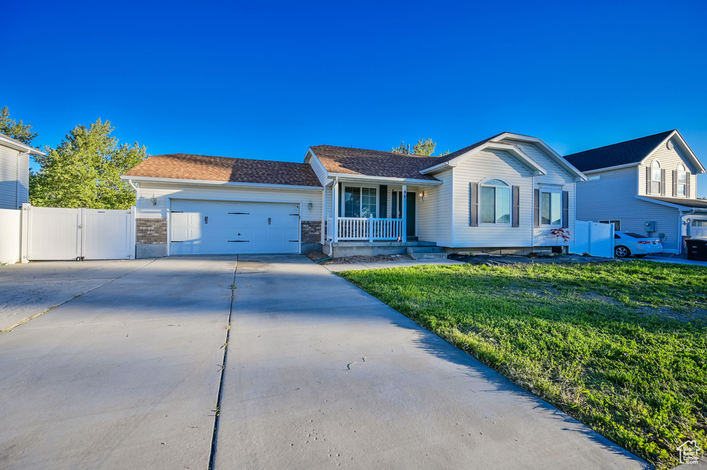 Single story home featuring a front lawn and a garage