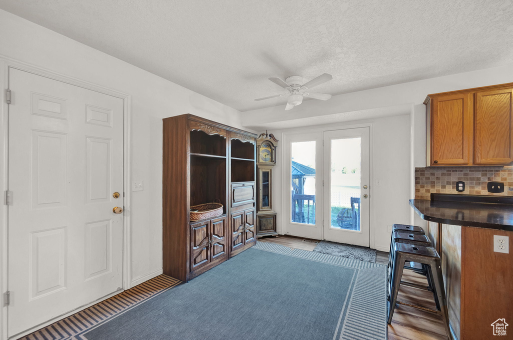 Interior space featuring ceiling fan and a textured ceiling