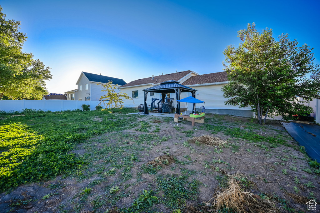 Rear view of property with a gazebo