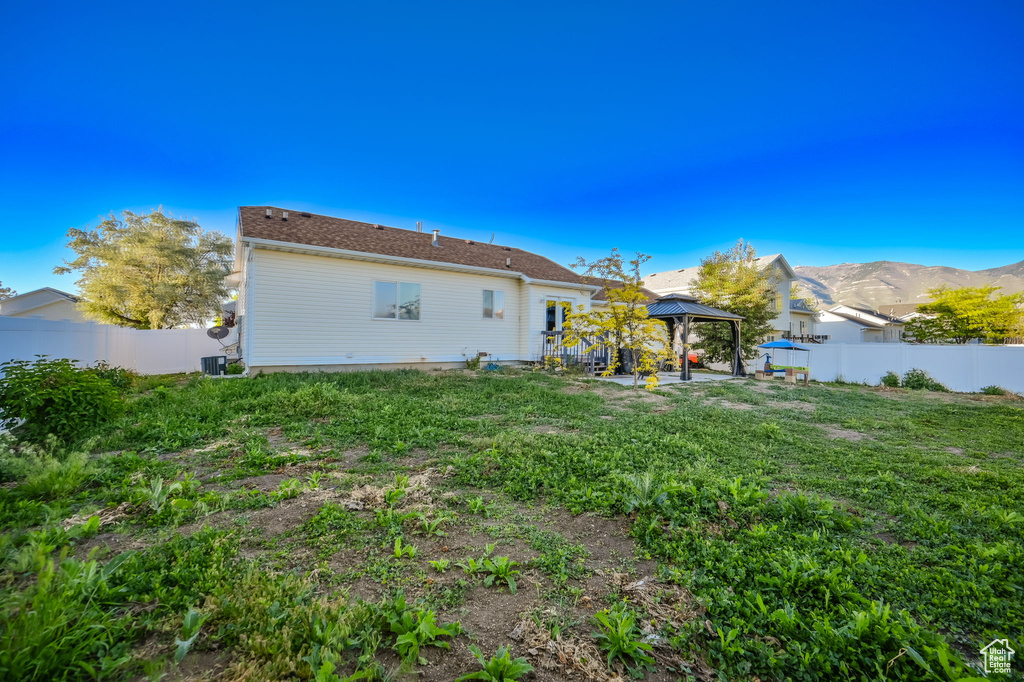 Back of house with a gazebo, a patio, a mountain view, and central AC unit