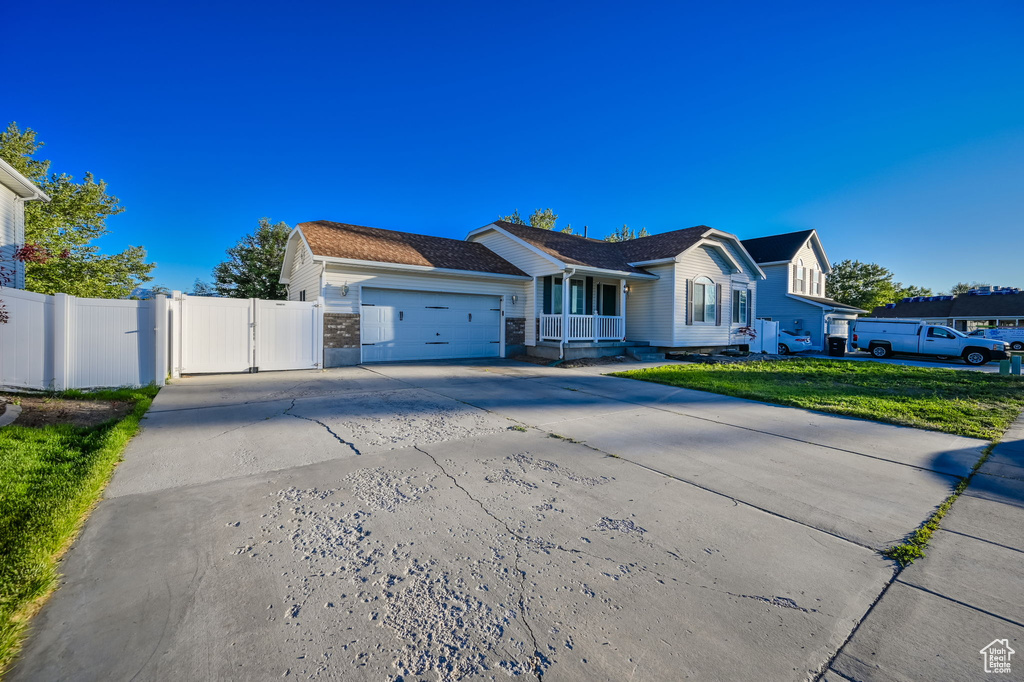 View of front of house with a garage and a front yard