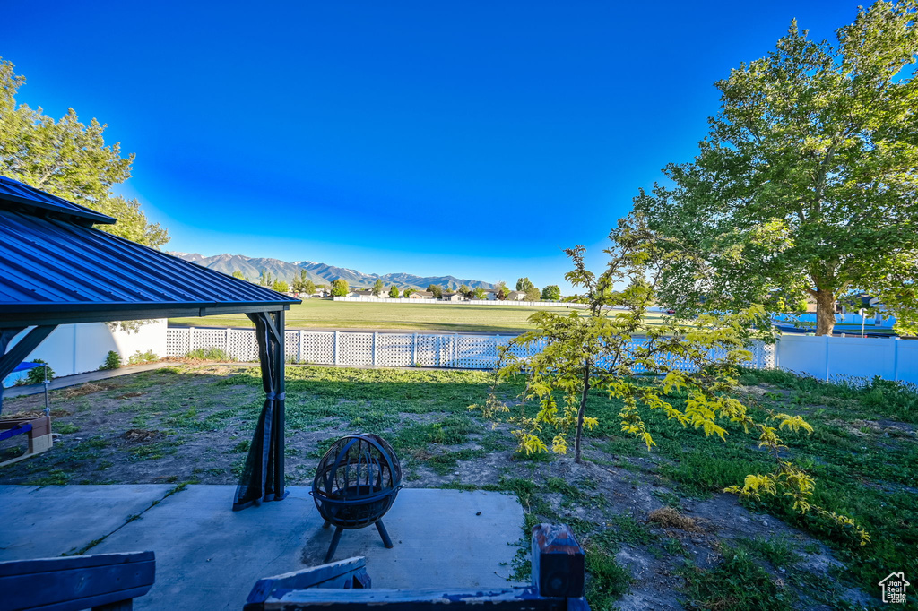 View of yard with a patio and a mountain view