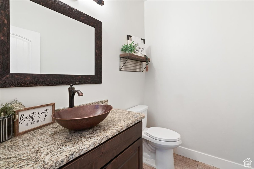 Bathroom with tile flooring, oversized vanity, and toilet