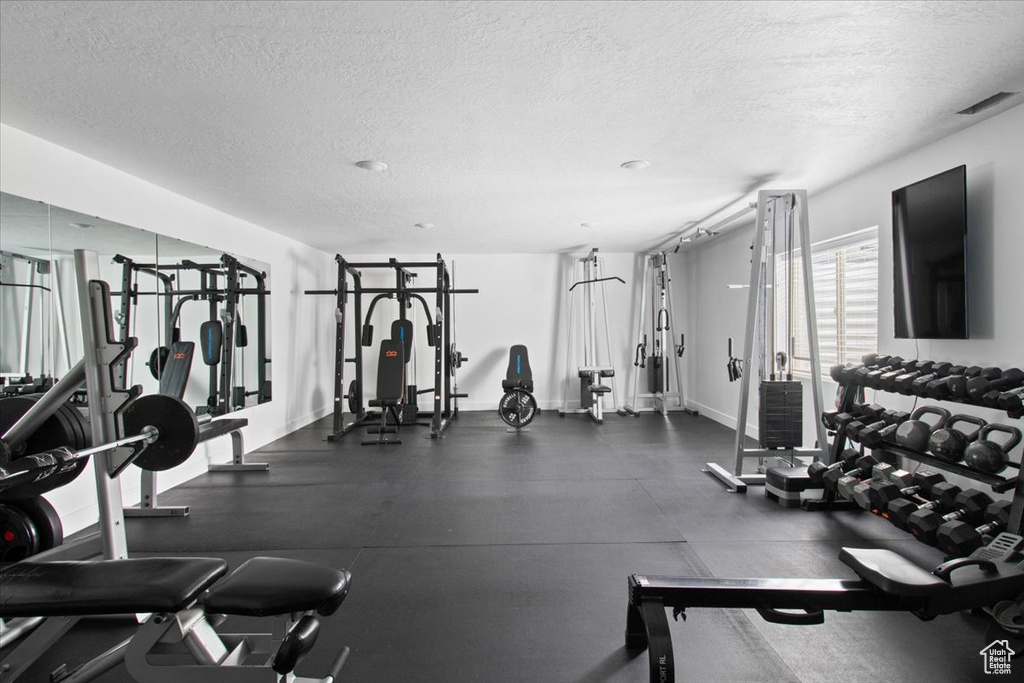 Workout area featuring a textured ceiling