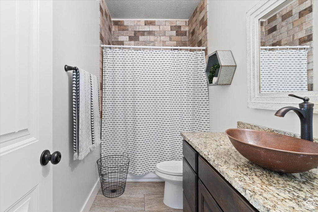 Bathroom featuring tile flooring, toilet, and vanity