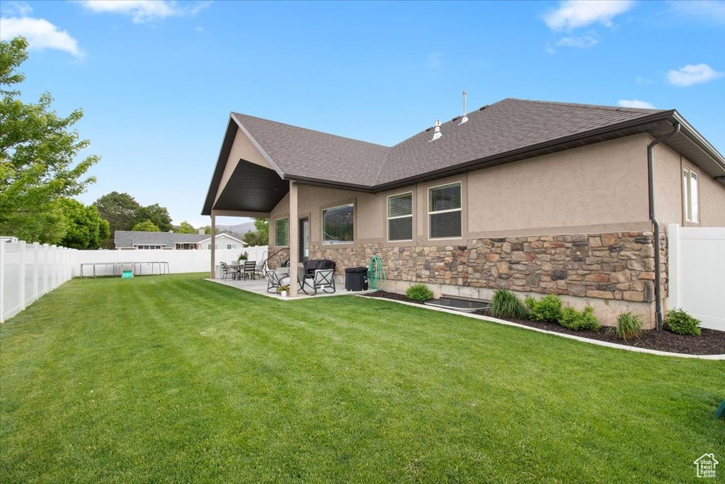 Back of house featuring a patio area and a yard