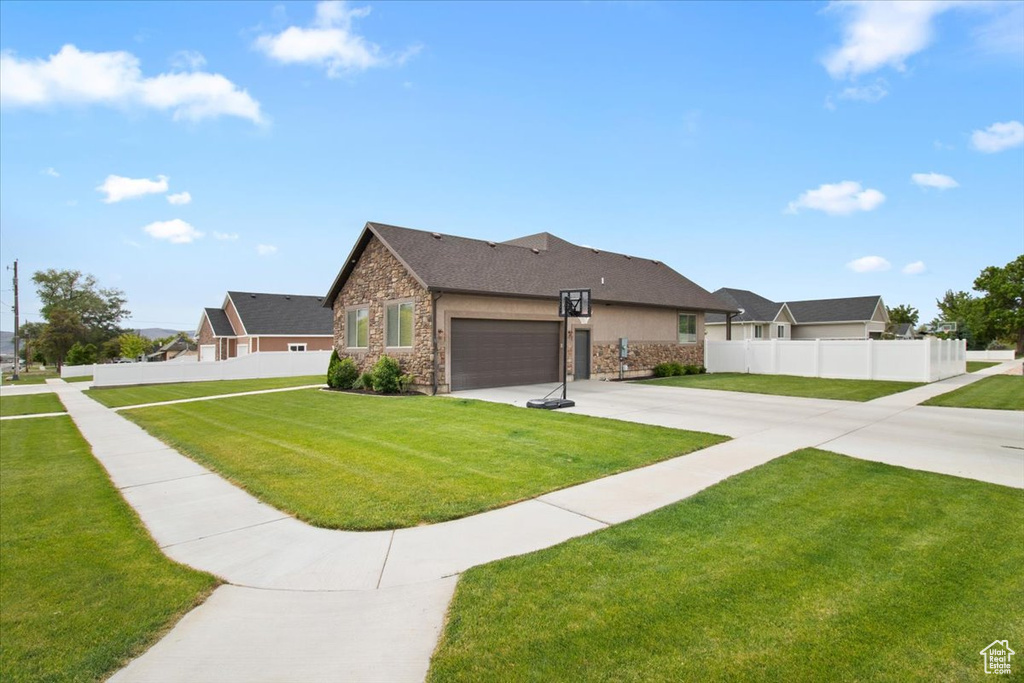 View of front of property with a garage and a front yard