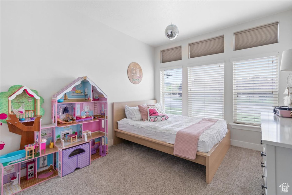 Carpeted bedroom featuring multiple windows