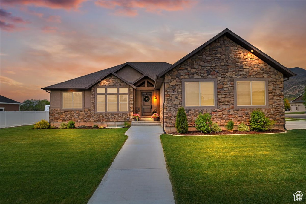 Craftsman-style home with a lawn