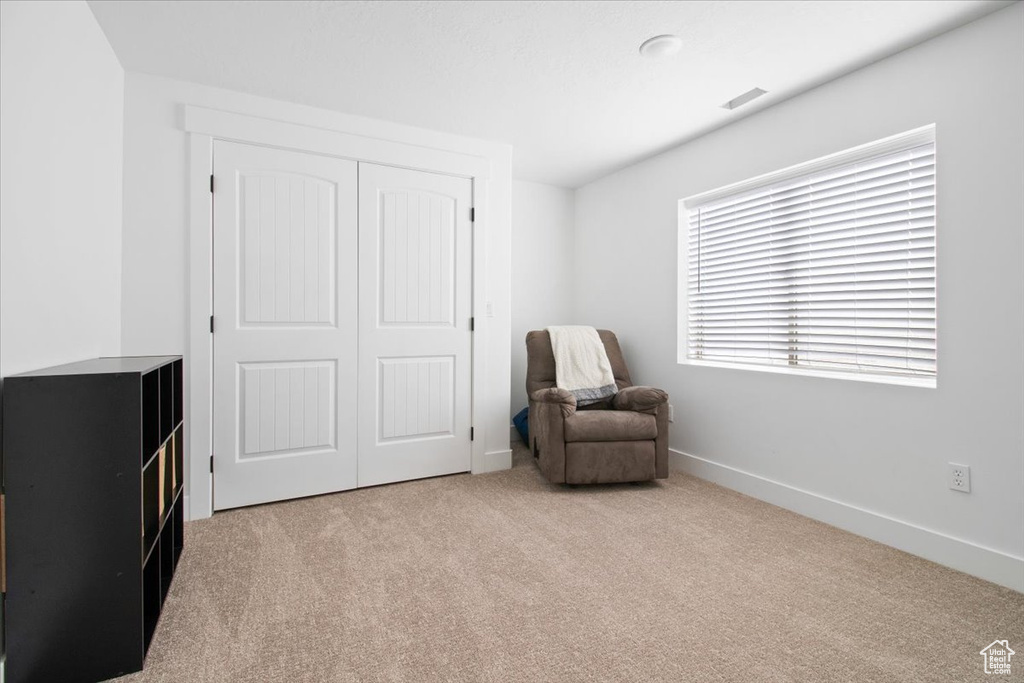 Sitting room featuring light carpet