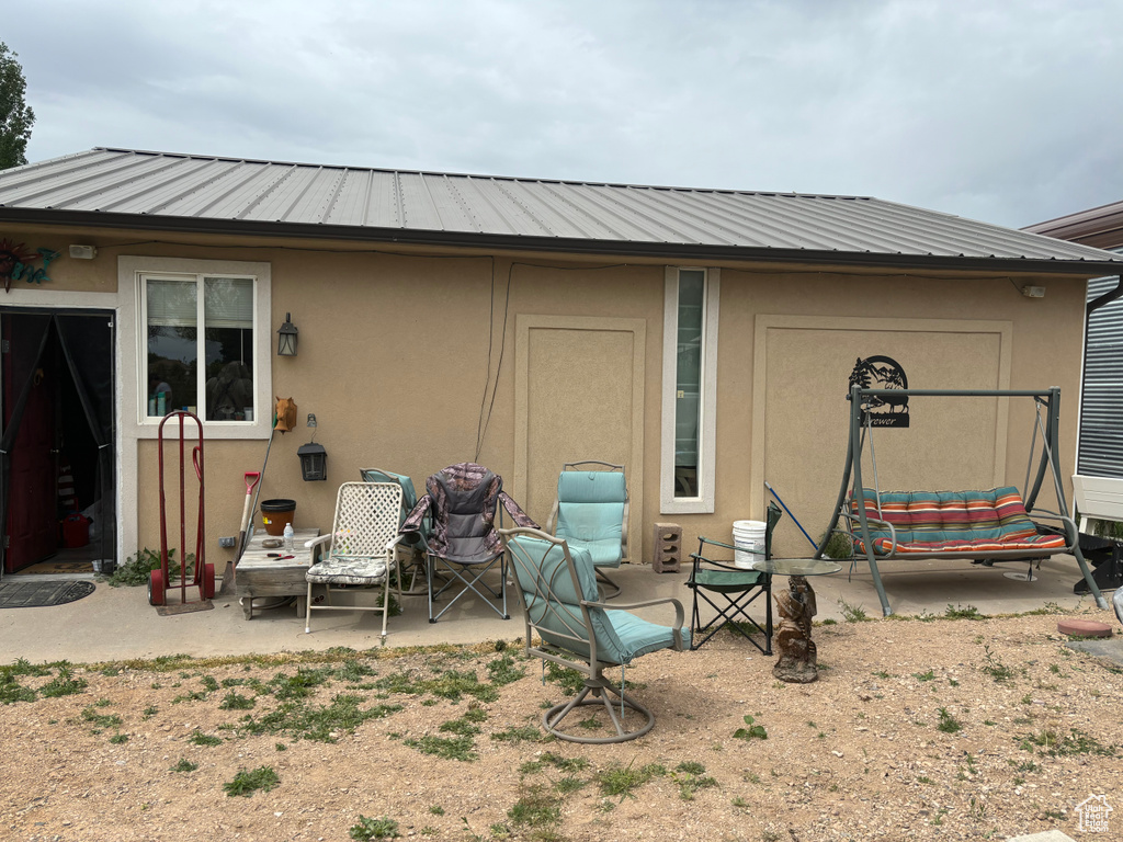 Rear view of house featuring a patio