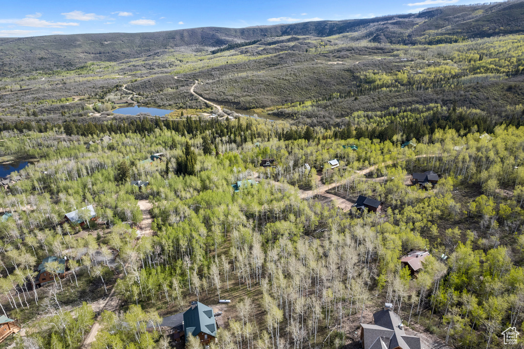 Birds eye view of property featuring a water and mountain view