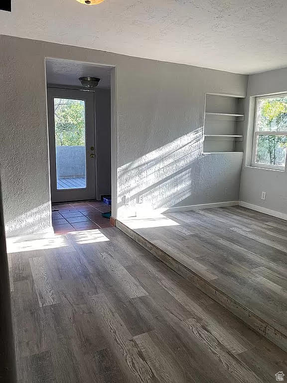 Empty room featuring wood-type flooring