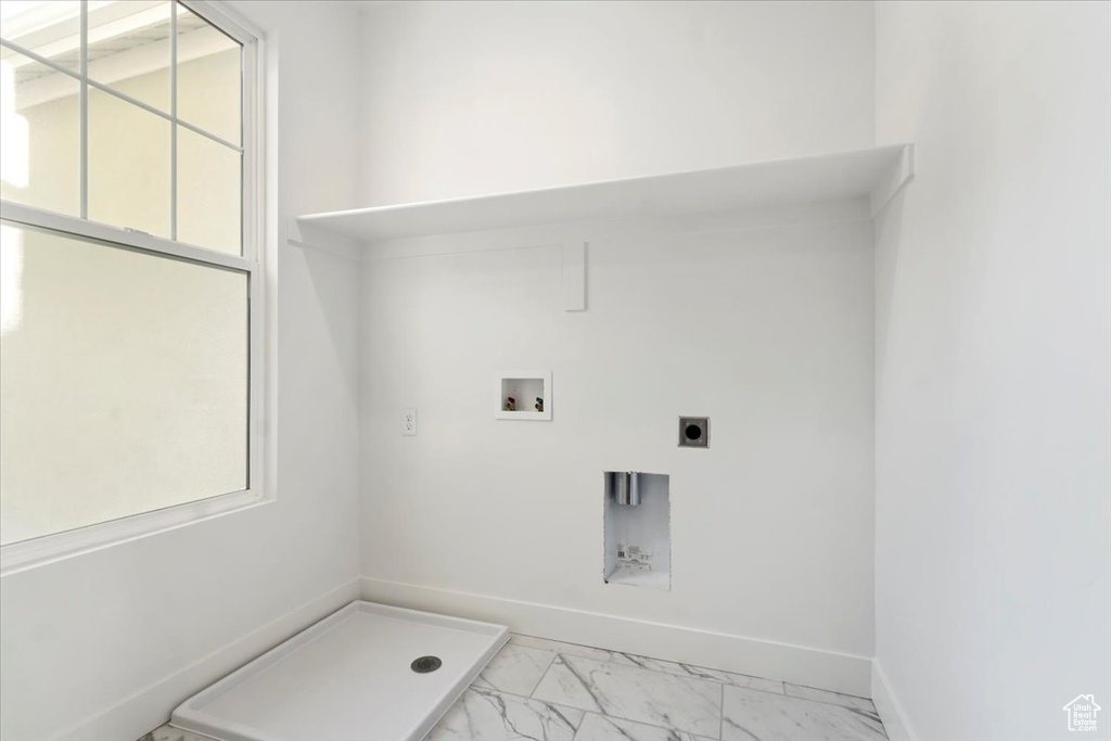Washroom featuring hookup for an electric dryer and washer hookup