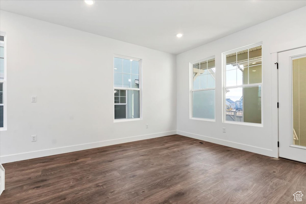 Spare room with dark hardwood / wood-style flooring