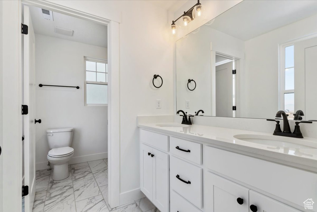 Bathroom featuring vanity and toilet