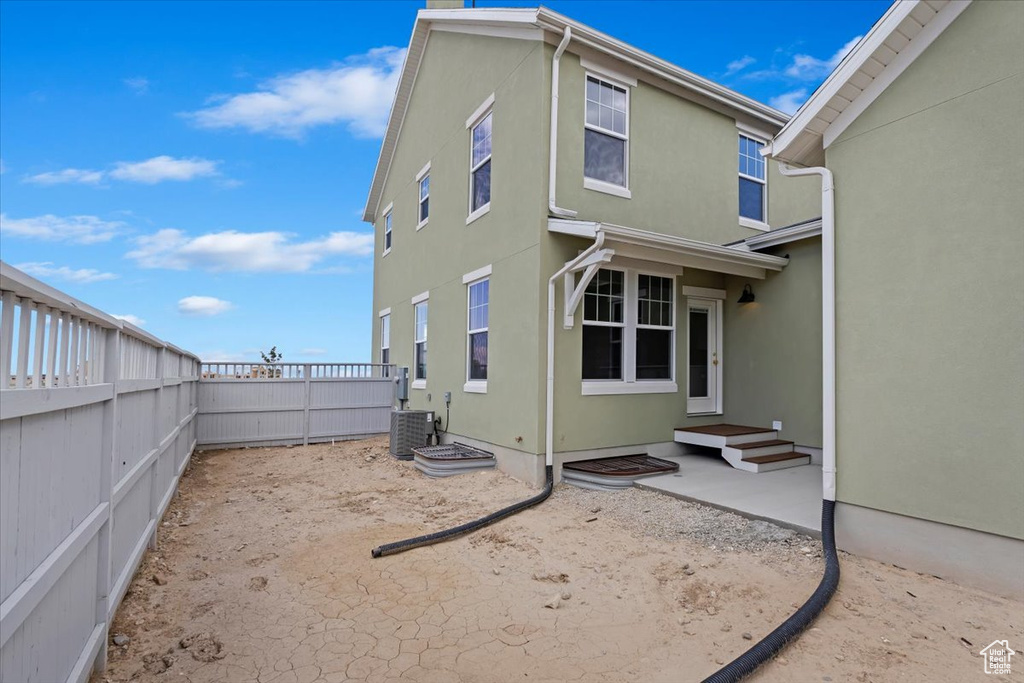 Rear view of property with central air condition unit