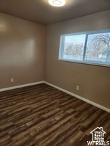 Unfurnished room featuring dark hardwood / wood-style flooring