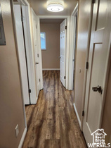 Corridor featuring dark hardwood / wood-style flooring