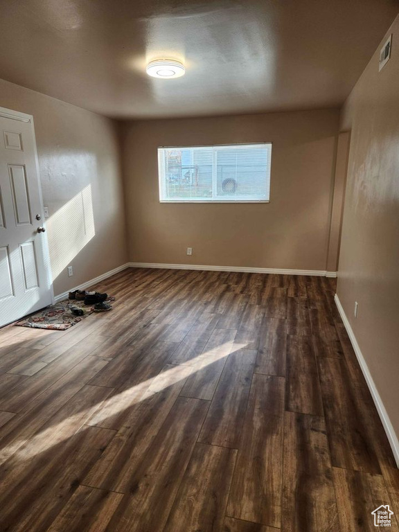 Unfurnished room featuring dark hardwood / wood-style flooring