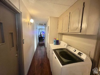 Laundry room with dark hardwood / wood-style floors, cabinets, and independent washer and dryer