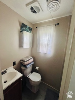 Bathroom featuring tile floors, toilet, and vanity