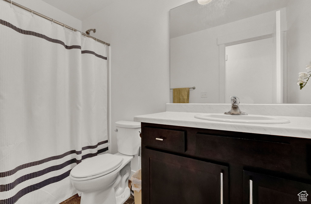 Bathroom featuring large vanity and toilet