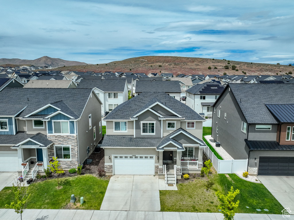 View of front of house with a garage and a mountain view