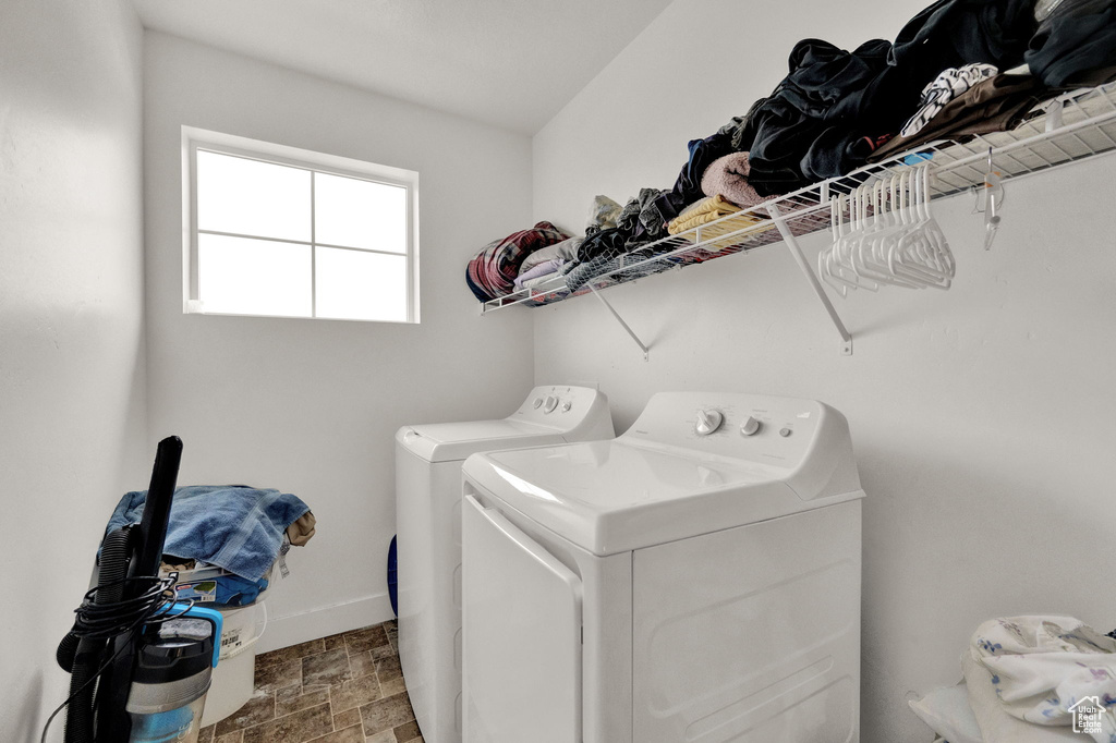 Washroom with washer and clothes dryer and tile flooring