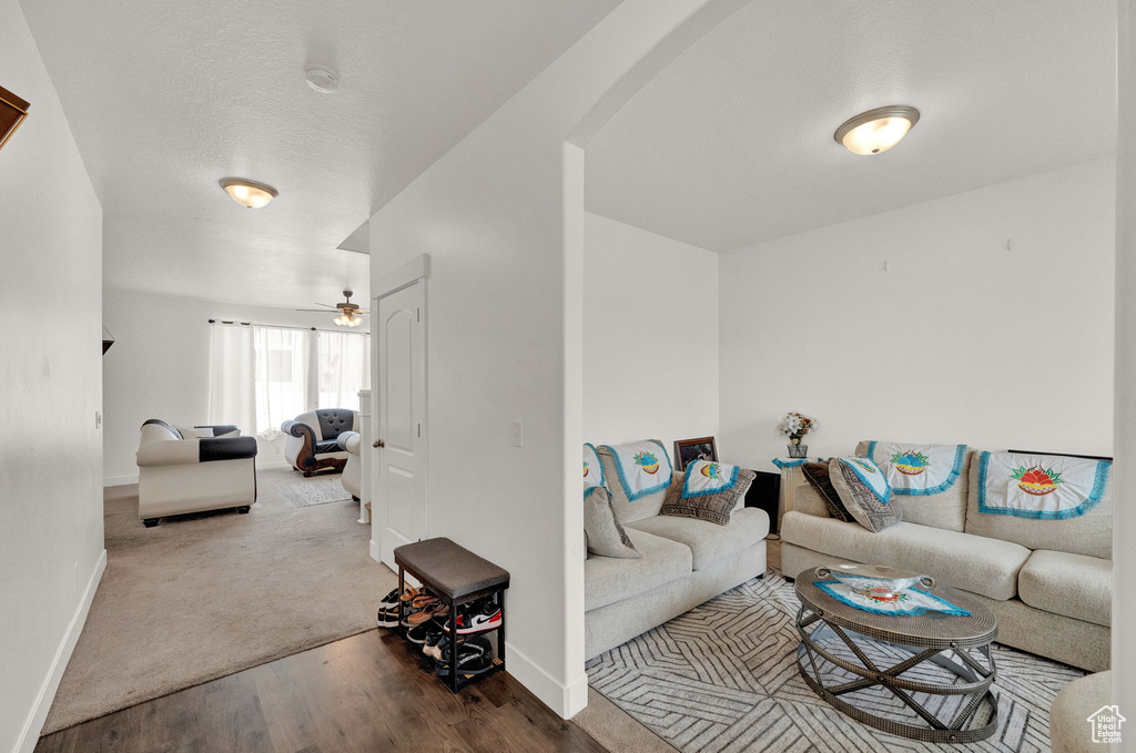 Living room with carpet flooring and ceiling fan