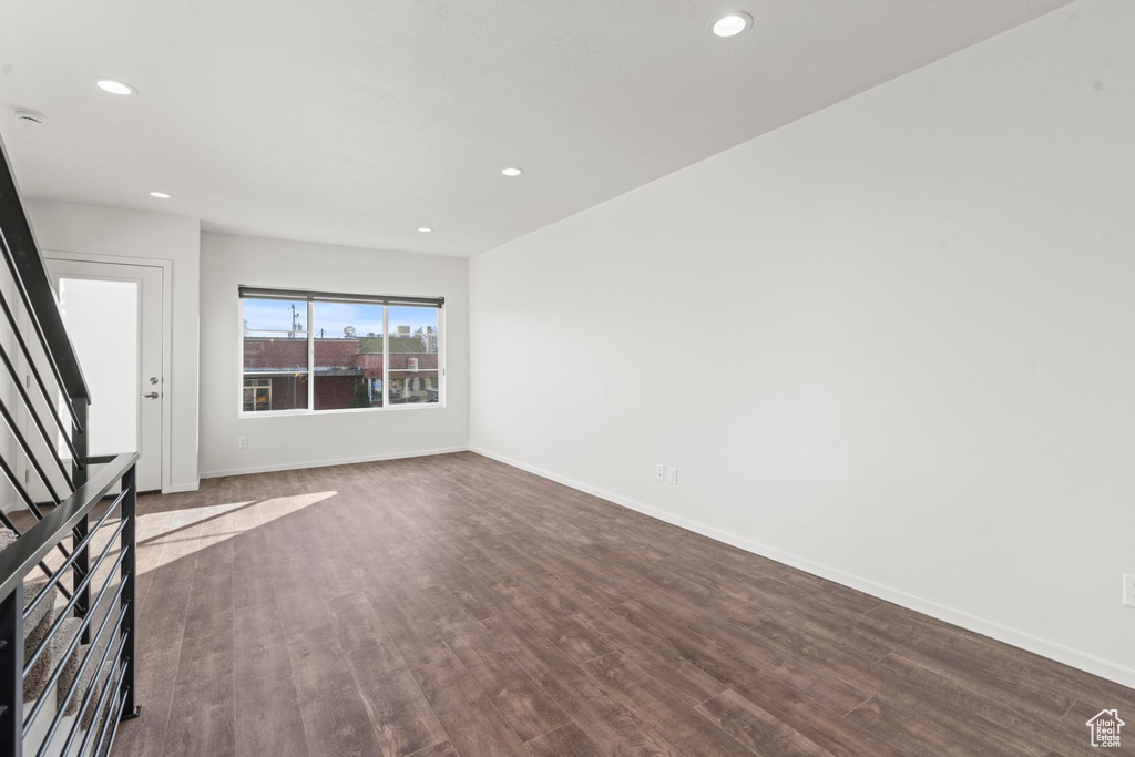 Unfurnished living room with dark wood-type flooring