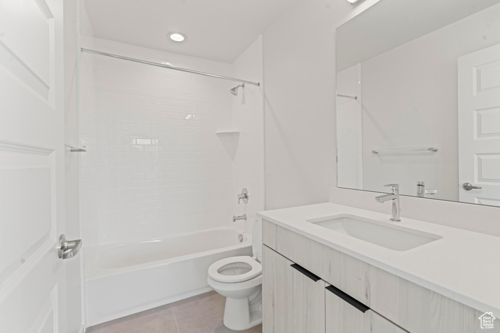 Full bathroom with tile floors, bathtub / shower combination, toilet, and vanity