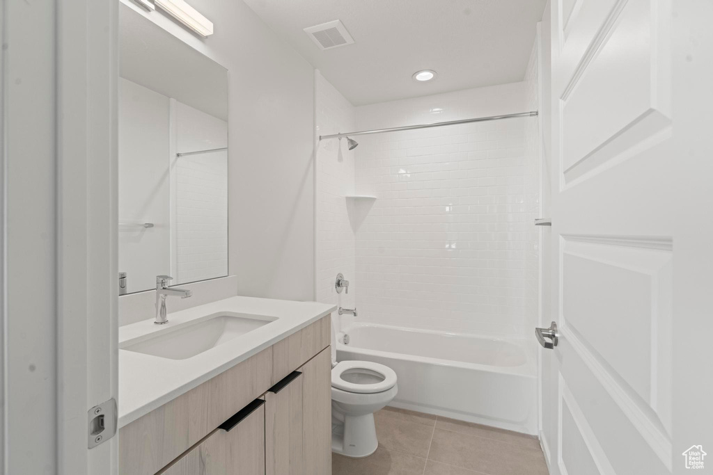 Full bathroom with tile flooring, oversized vanity, shower / tub combination, and toilet