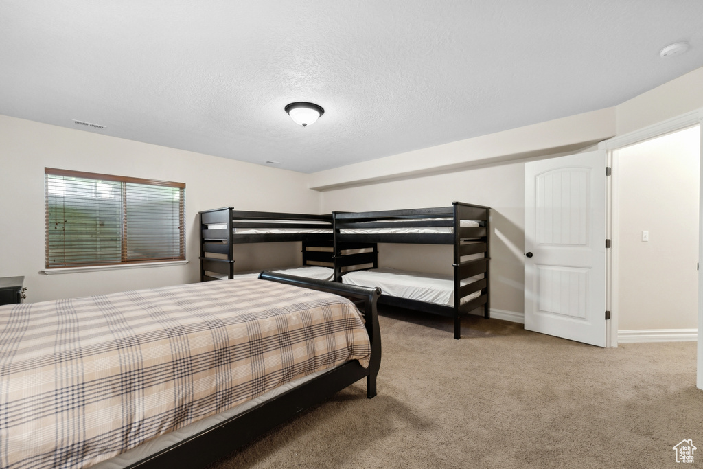 Bedroom featuring light carpet