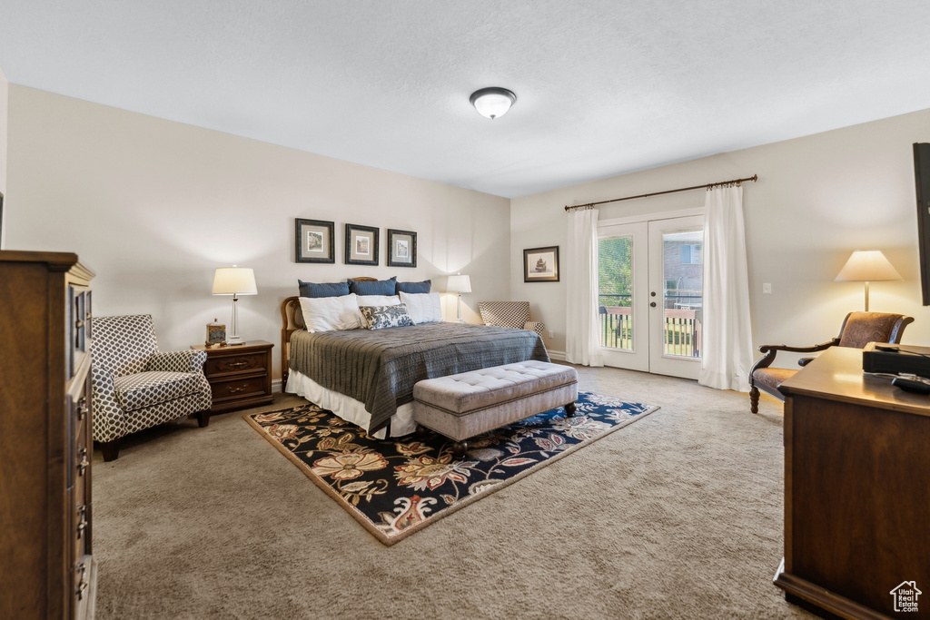 Bedroom with french doors, carpet, and access to exterior