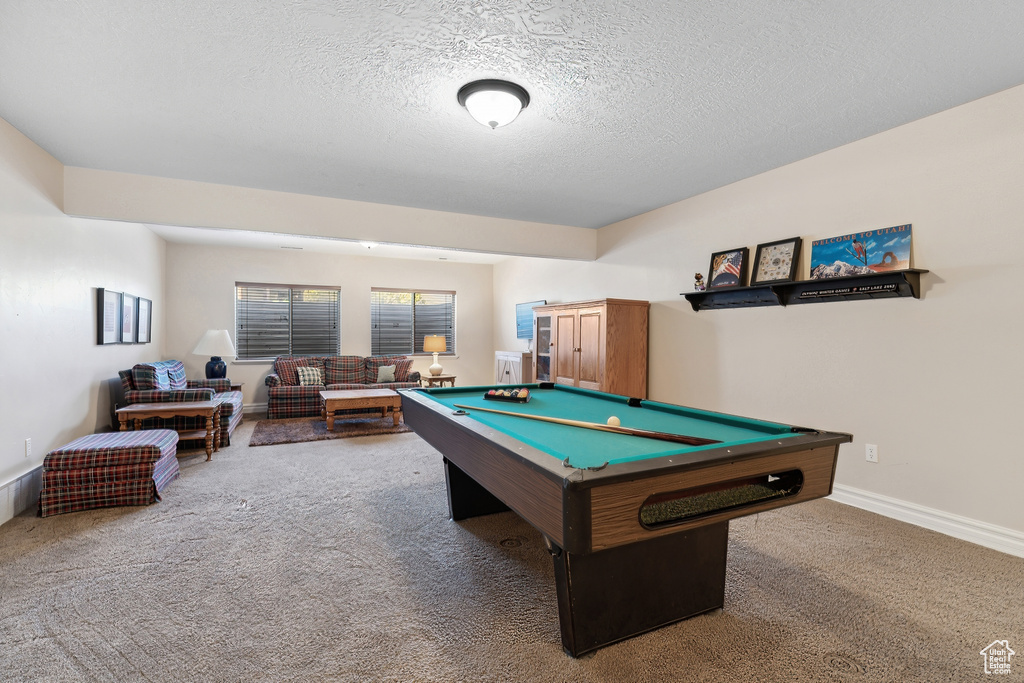 Playroom with billiards, a textured ceiling, and dark carpet