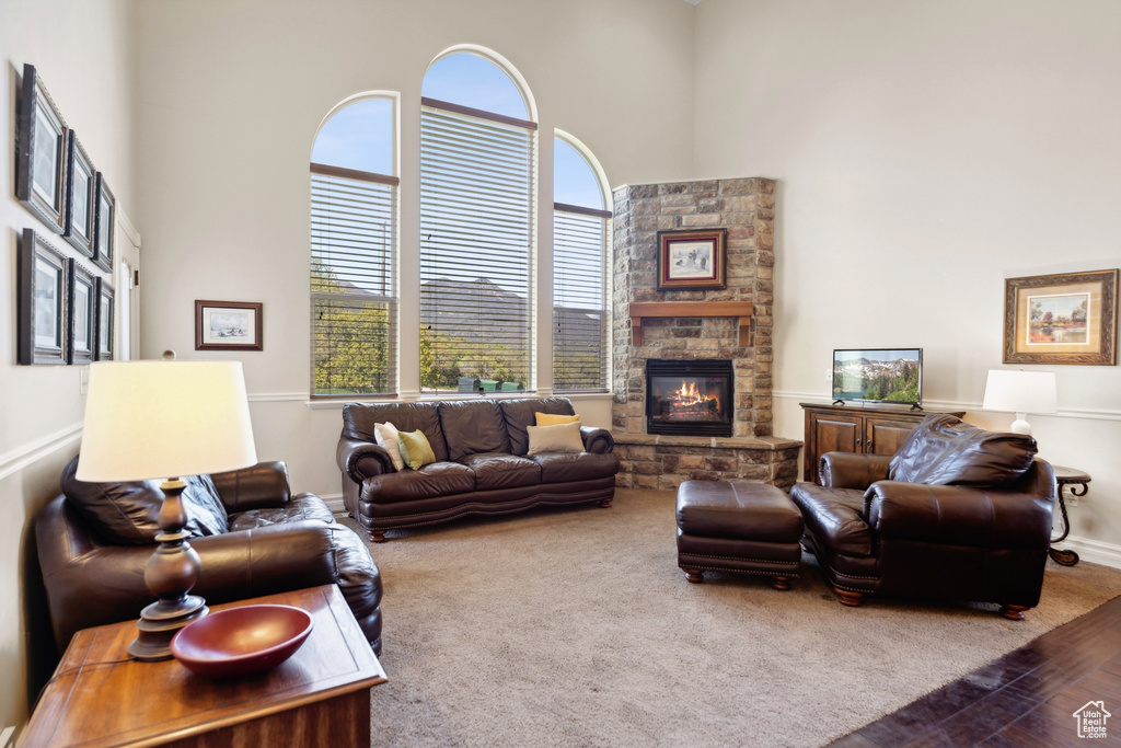 Living room with a stone fireplace and a towering ceiling