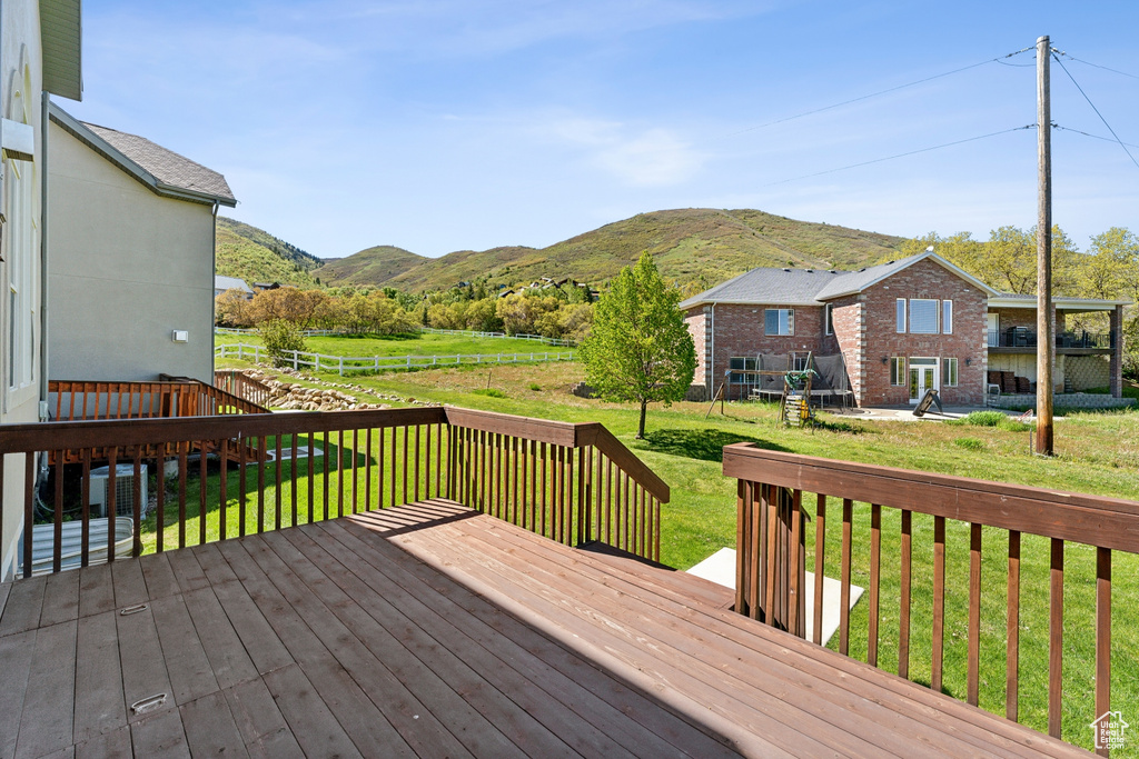 Wooden terrace with a yard and a mountain view