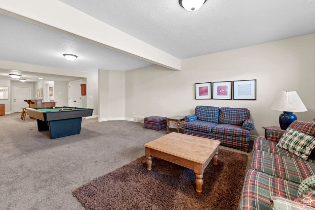 Interior space with beamed ceiling, carpet floors, and pool table