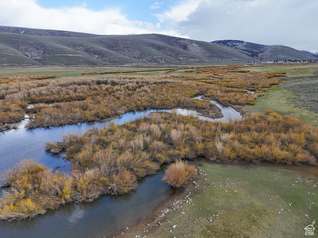 Drone / aerial view featuring a water and mountain view