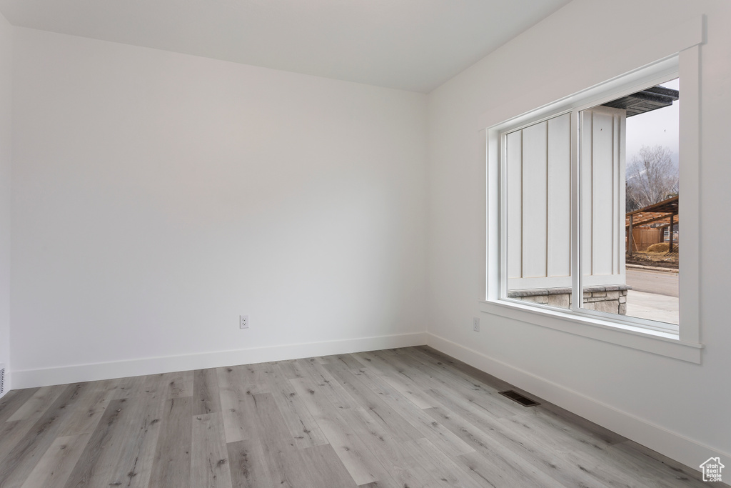 Empty room with light wood-type flooring