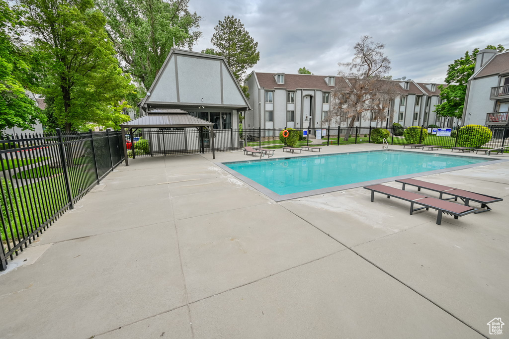 View of pool with a patio and a gazebo