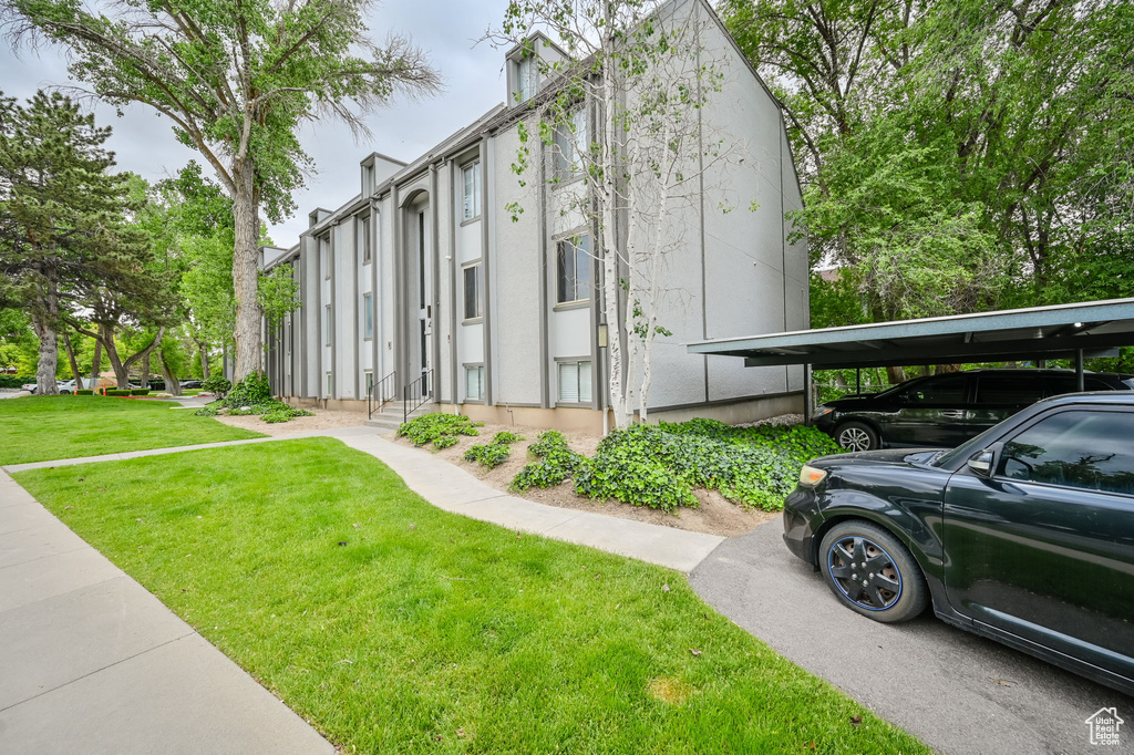 View of property exterior featuring a lawn