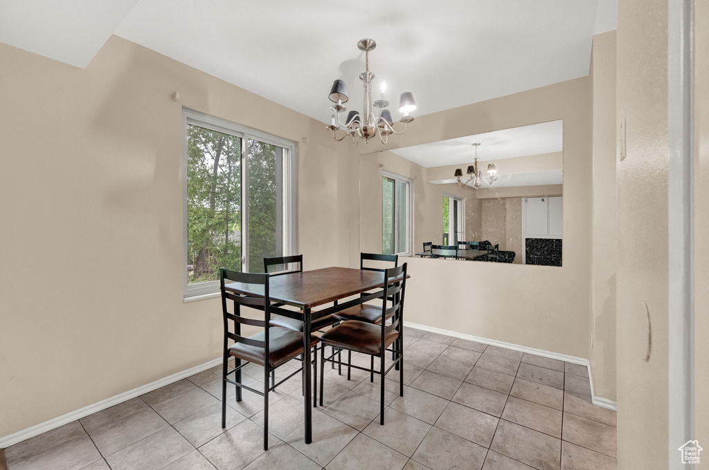 Dining room featuring an inviting chandelier and light tile flooring