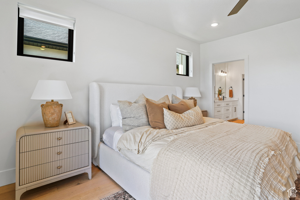 Bedroom featuring ceiling fan, ensuite bathroom, and light hardwood / wood-style floors