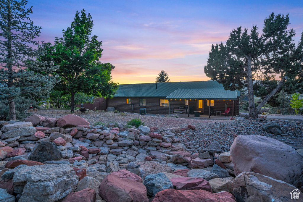 Back house at dusk with a patio area